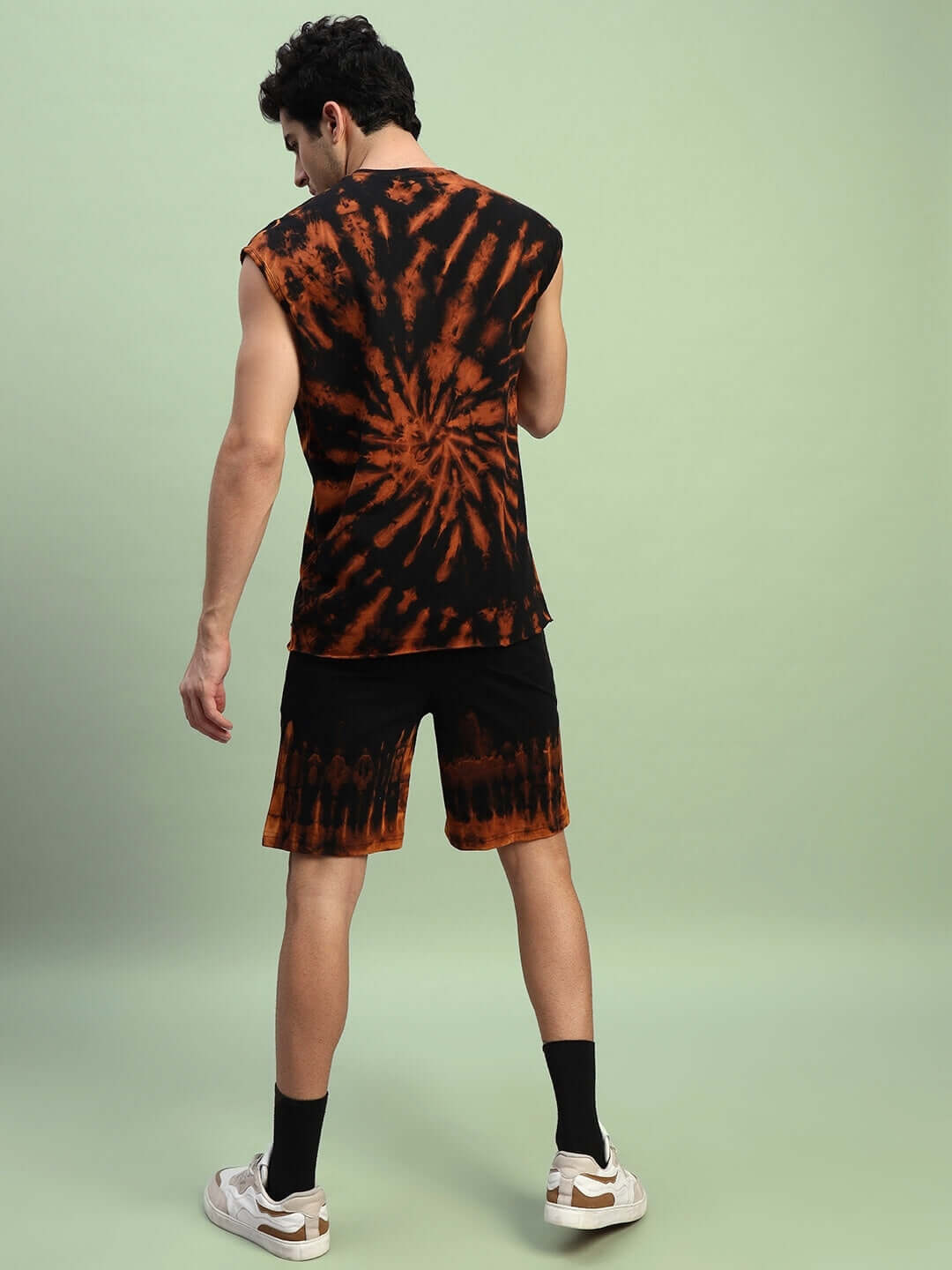 Model wearing MUSCLE TEE RIPPED TIE-DYE CO-ORD SET in black, showcasing premium cotton French Terry fabric with vibrant tie-dye design.