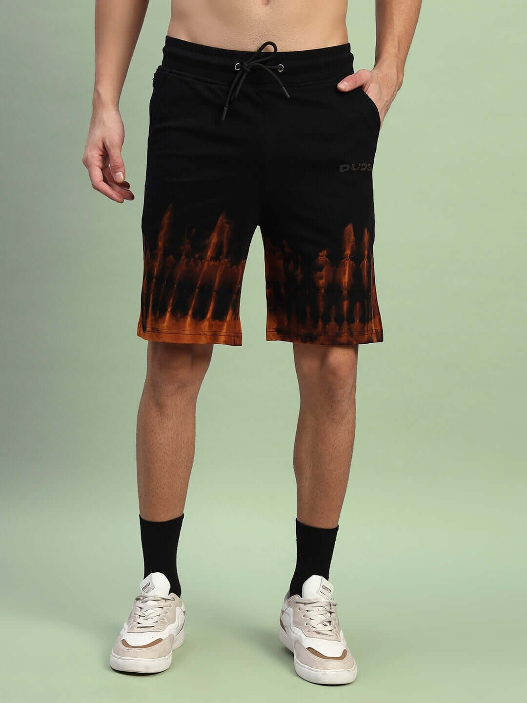 Model wears black tie-dye muscle tee co-ord set, made from premium cotton with elastane, showcasing a stylish and comfortable fit.