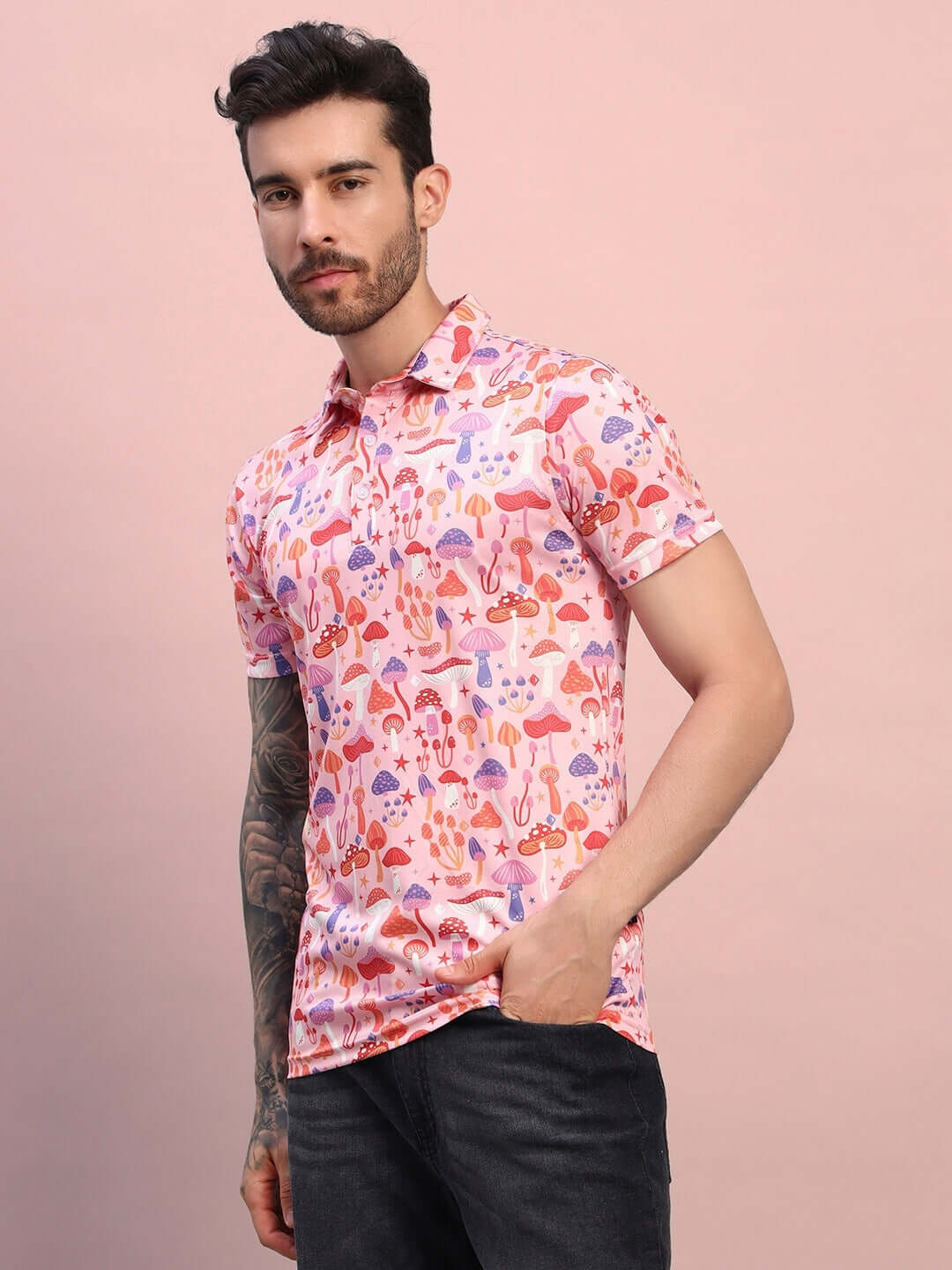 Men's pink multi mushroom print regular fit t-shirt made of sports polyester fabric, ideal for casual wear, modeled against a pink background.