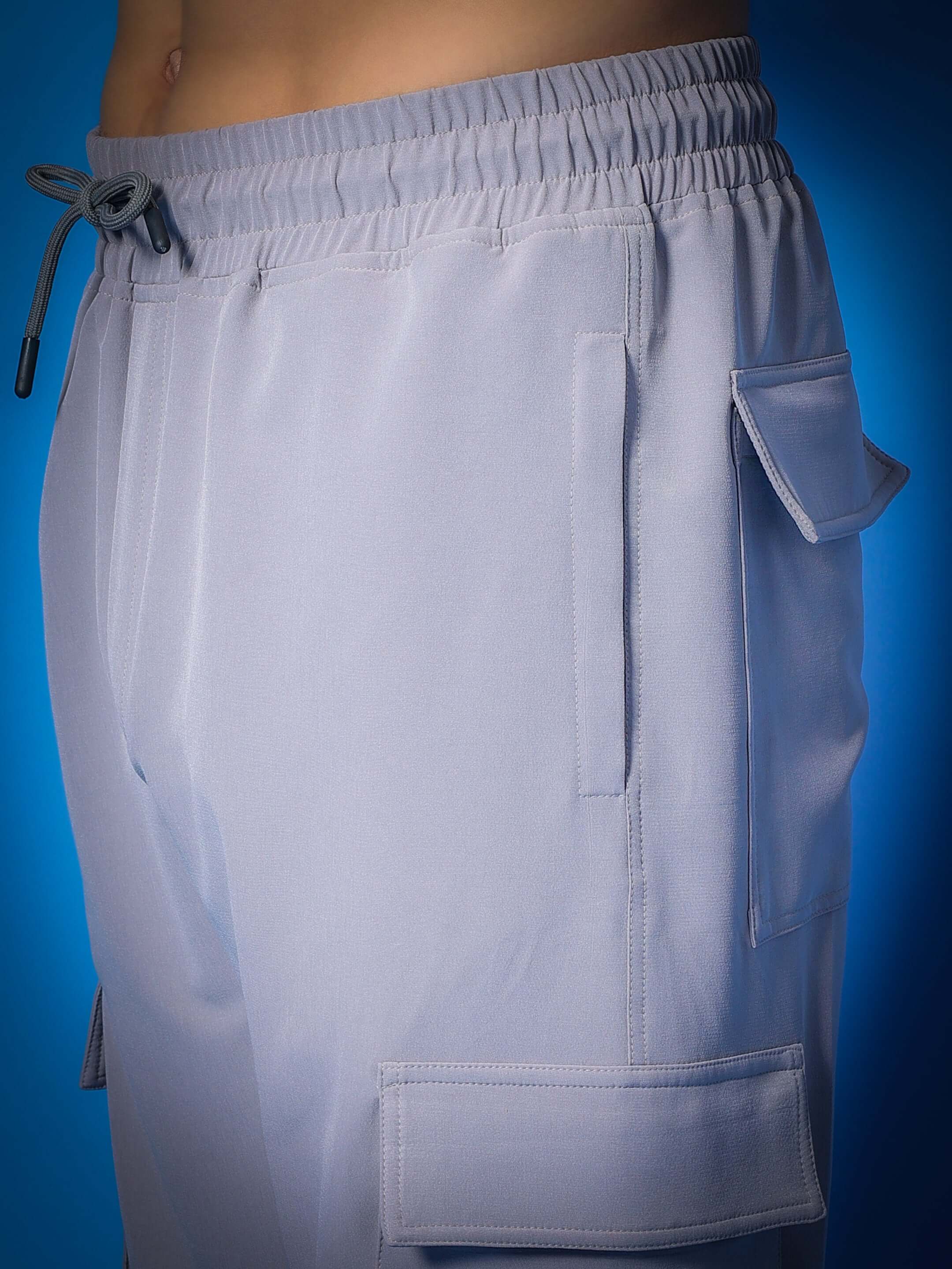 Grey Myriad Relaxed Fit Cargo Pants with pockets, featuring elastic waist and drawstring, customizable for perfect fit.