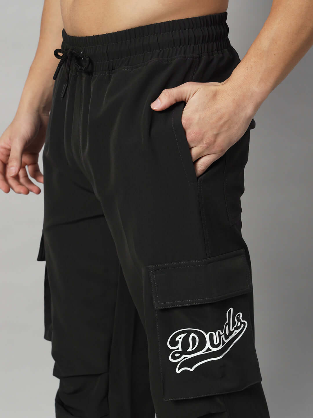 Black Myriad Relaxed Fit Cargo Pants with pocket and Duds logo, customizable size available.