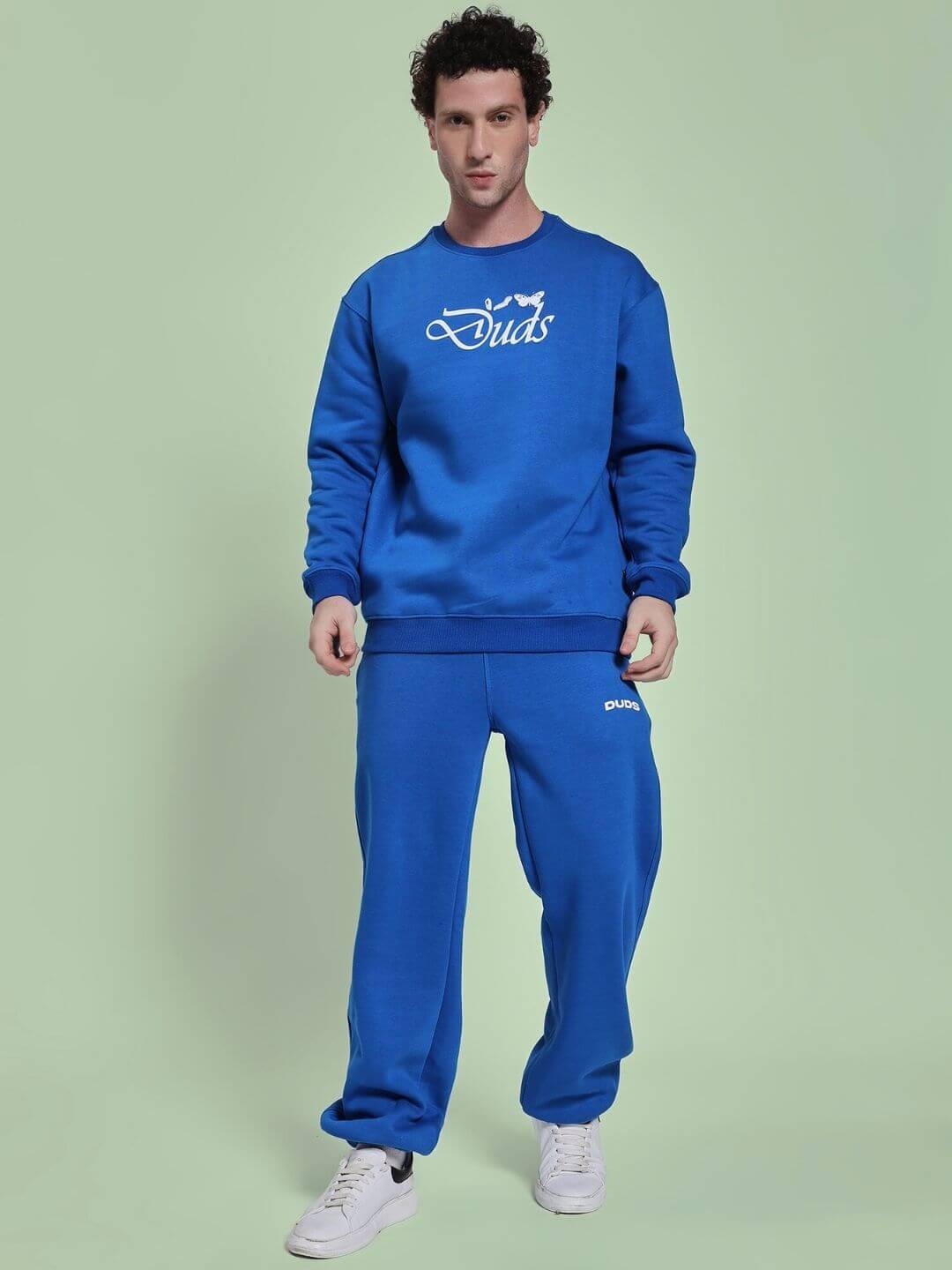 Man wearing NATURE LINK FLEECE CO-ORD SET ROYAL BLUE with a relaxed fit, showcasing cozy fleece fabric in vibrant royal blue.