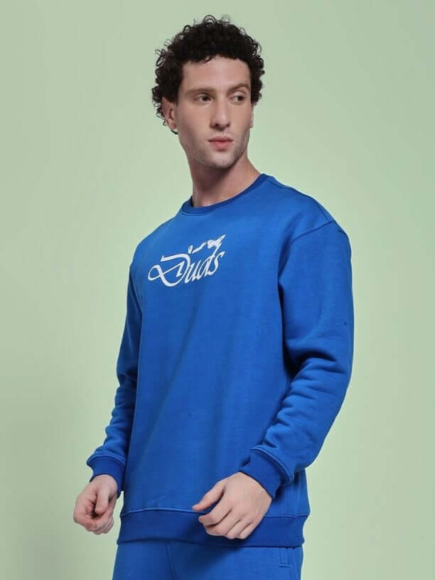 Man wearing NATURE LINK FLEECE SWEATSHIRT ROYAL BLUE, showcasing its cozy fleece fabric and modern design ideal for casual outings and comfort.