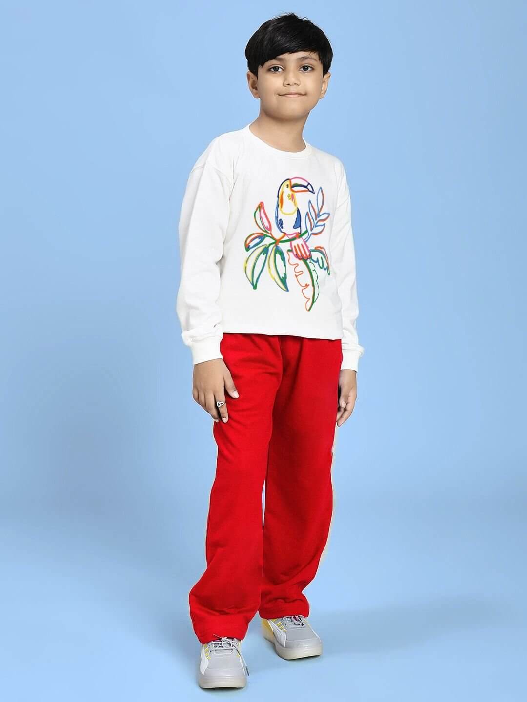 Boy wearing NATURE VIBES BIRD PRINT CO-ORD FOR BOYS AND GIRLS WHITE RED outfit with a colorful bird design on a blue background.