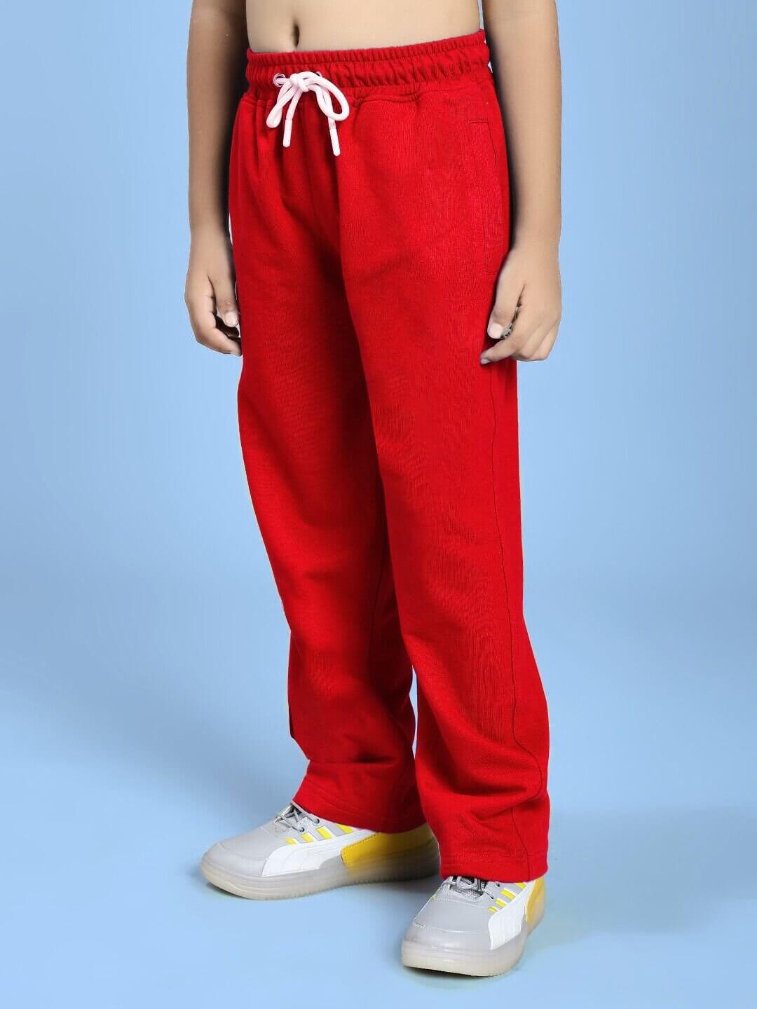 Child wearing NATURE VIBES RELAXED FIT JOGGER FOR BOYS AND GIRLS RED standing on a blue background