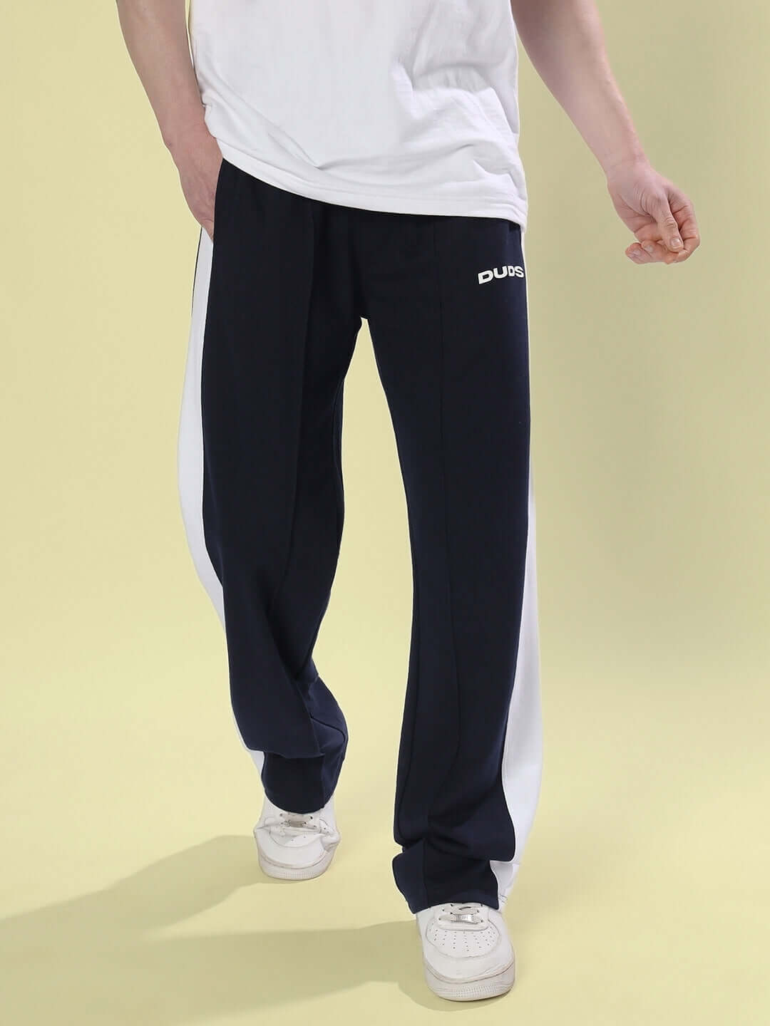 Navy blue side seam joggers by DUDS, customizable fit, worn with white sneakers, showcasing a relaxed and stylish look.