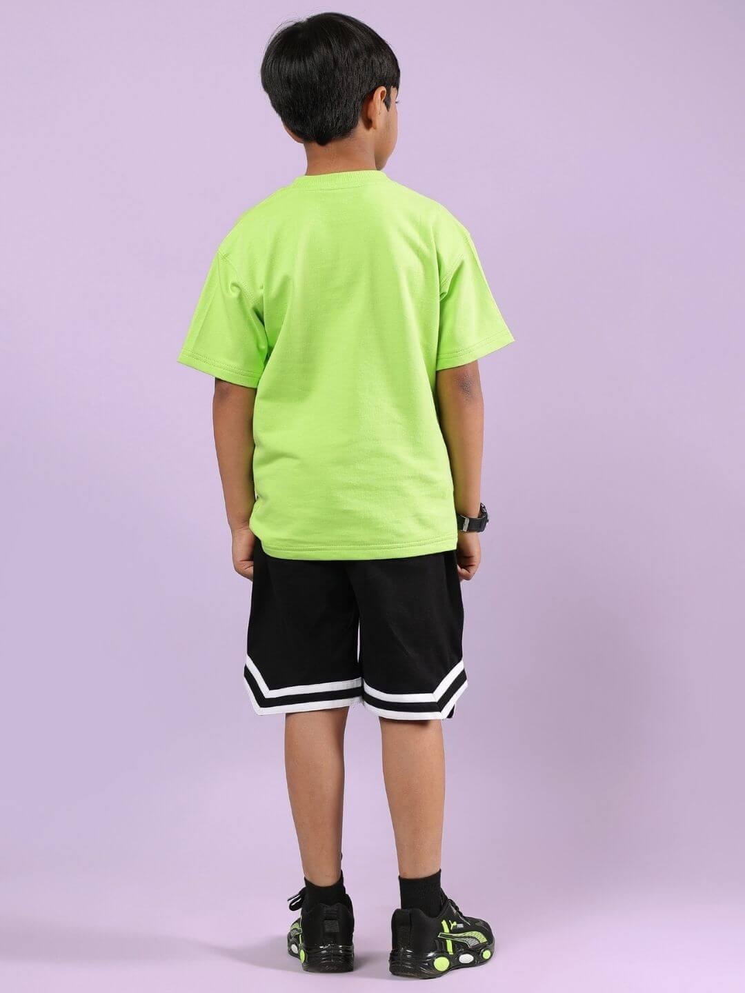 Child wearing Nendoroid printed co-ord set featuring neon green T-shirt and black shorts, showcasing trendy and comfortable kids' fashion.