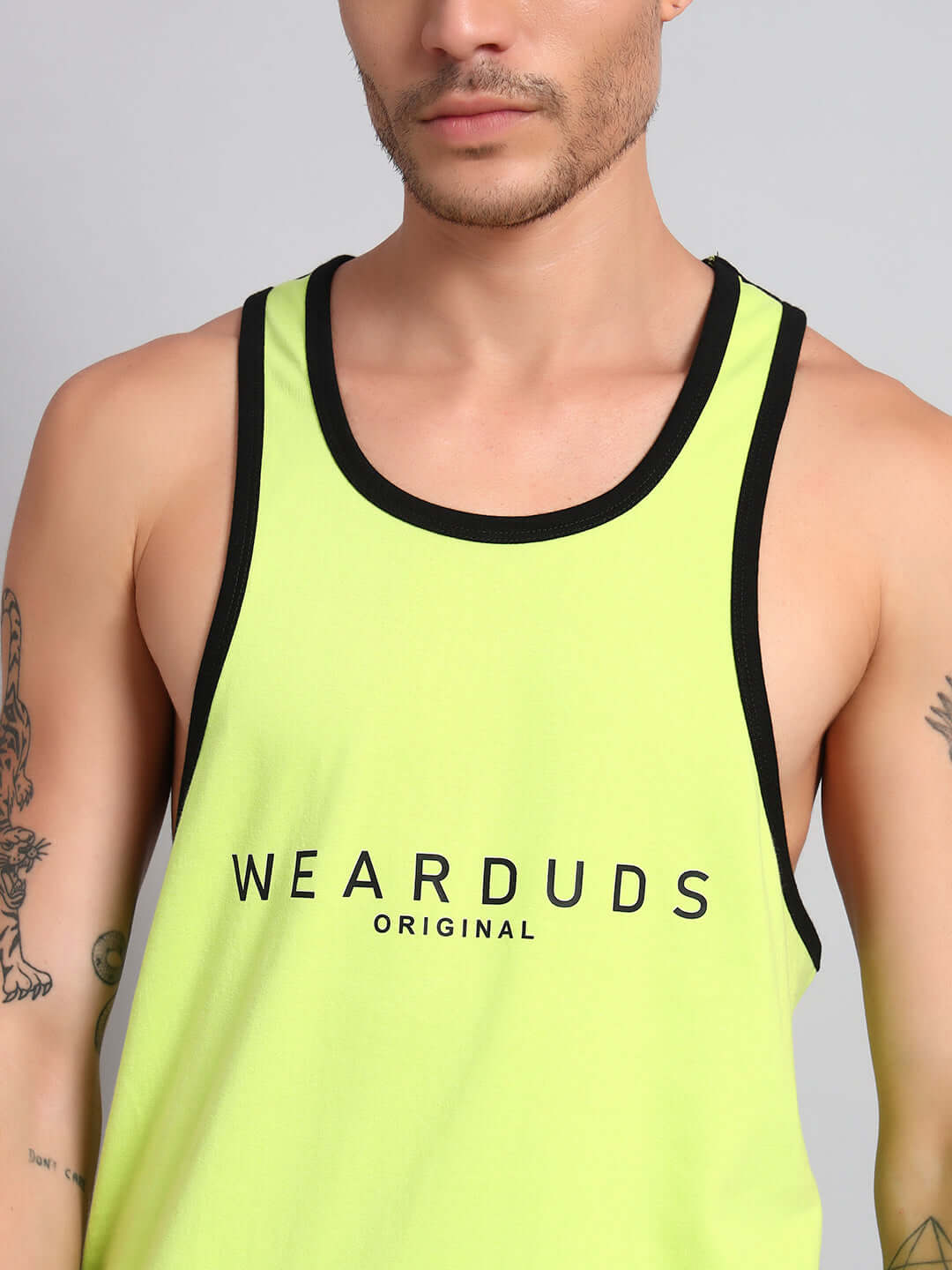 Man wearing NEO GYM T-shirt in neon green with 'WEARDUDS ORIGINAL' text; customizable fit available for prepaid orders.