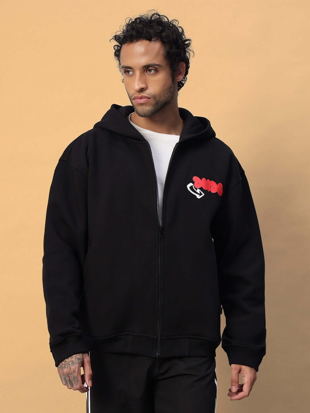 Man wearing NEVER BE AFRAID FLEECE HOODIE BLACK, showcasing premium fleece fabric and "Never Be Afraid" graphic.