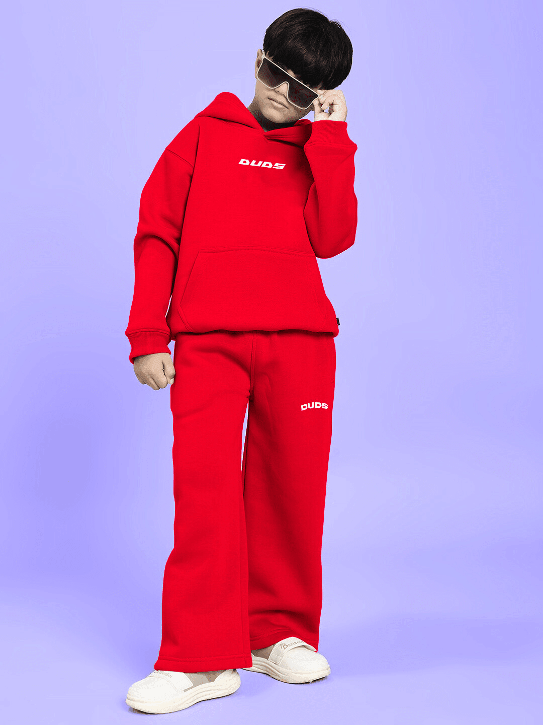 Boy wearing NEVER BE MY RIVAL PRINT FLEECE CO-ORD FOR BOYS GIRLS RED, featuring bold red hue and playful graphic print, standing confidently.