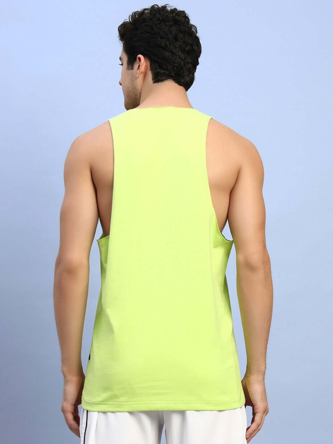 Rear view of model wearing neon green 'Never Forget' printed gym T-shirt by DUDS for activewear.