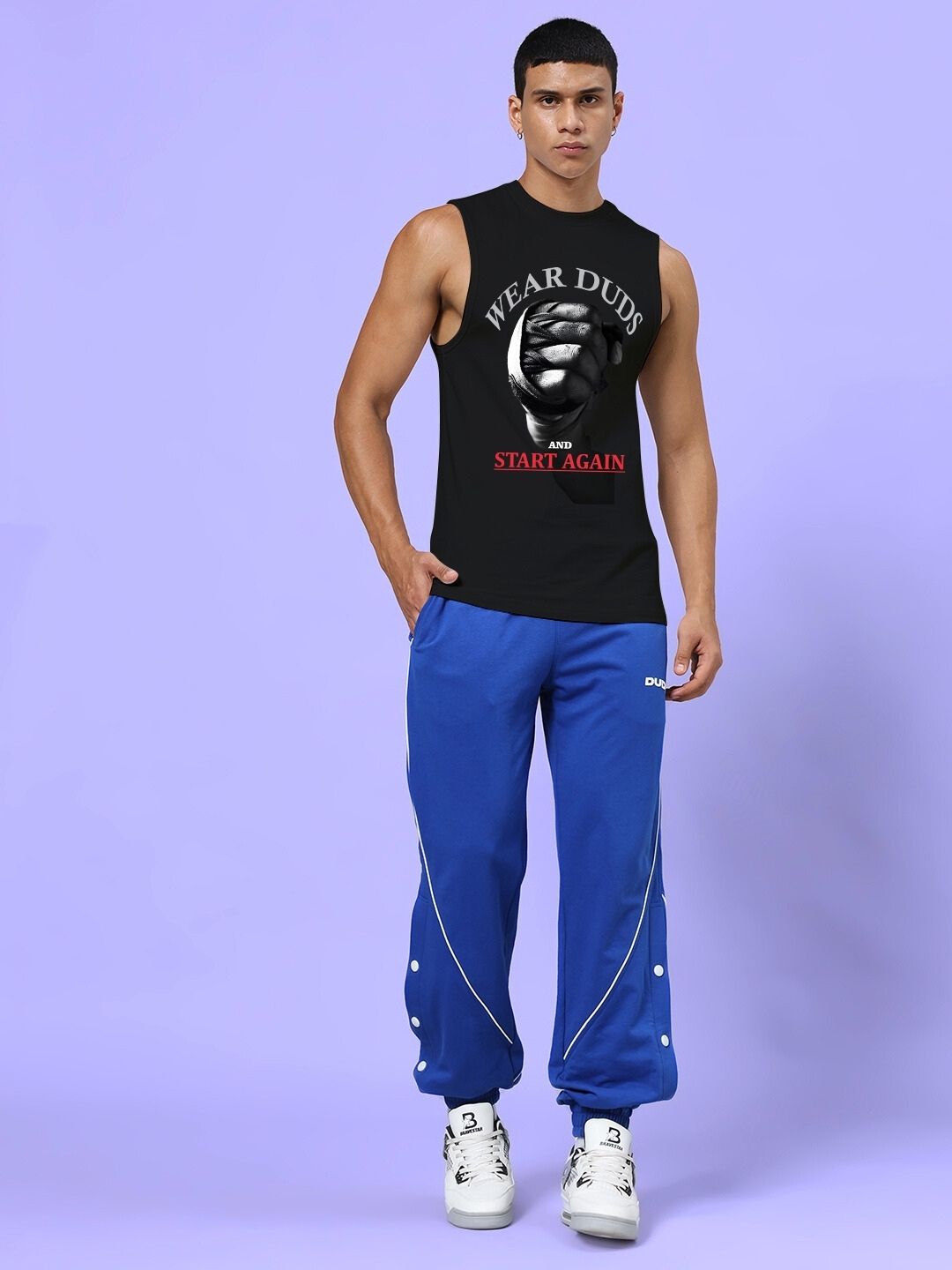 Man wearing NEVER QUIT START AGAIN GYM CO-ORD SET BLACK ROYAL BLUE showcasing athletic fashion.