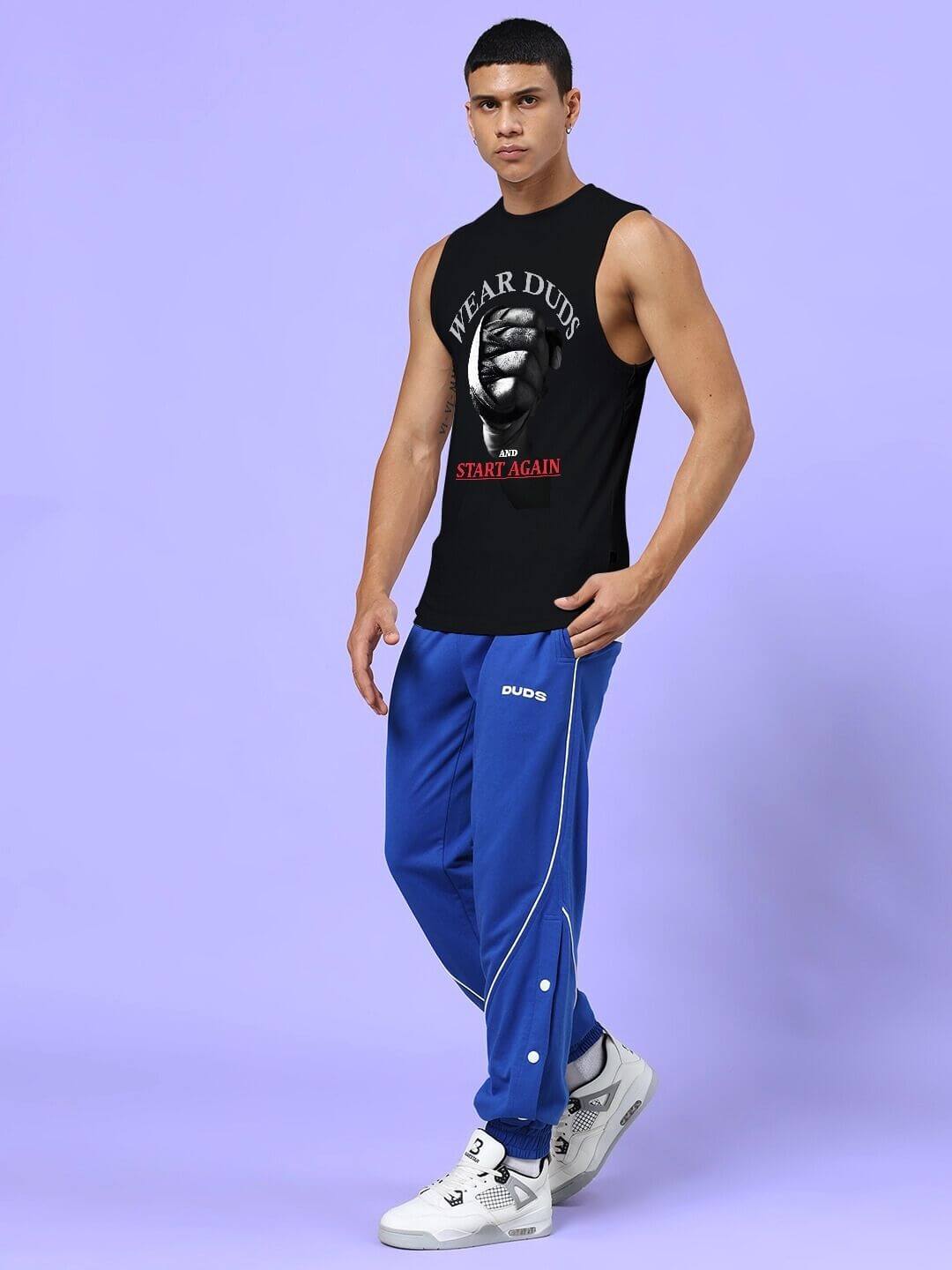 Man wearing NEVER QUIT START AGAIN GYM CO-ORD SET BLACK ROYAL BLUE, featuring motivational slogan, stylish sportswear for high performance.