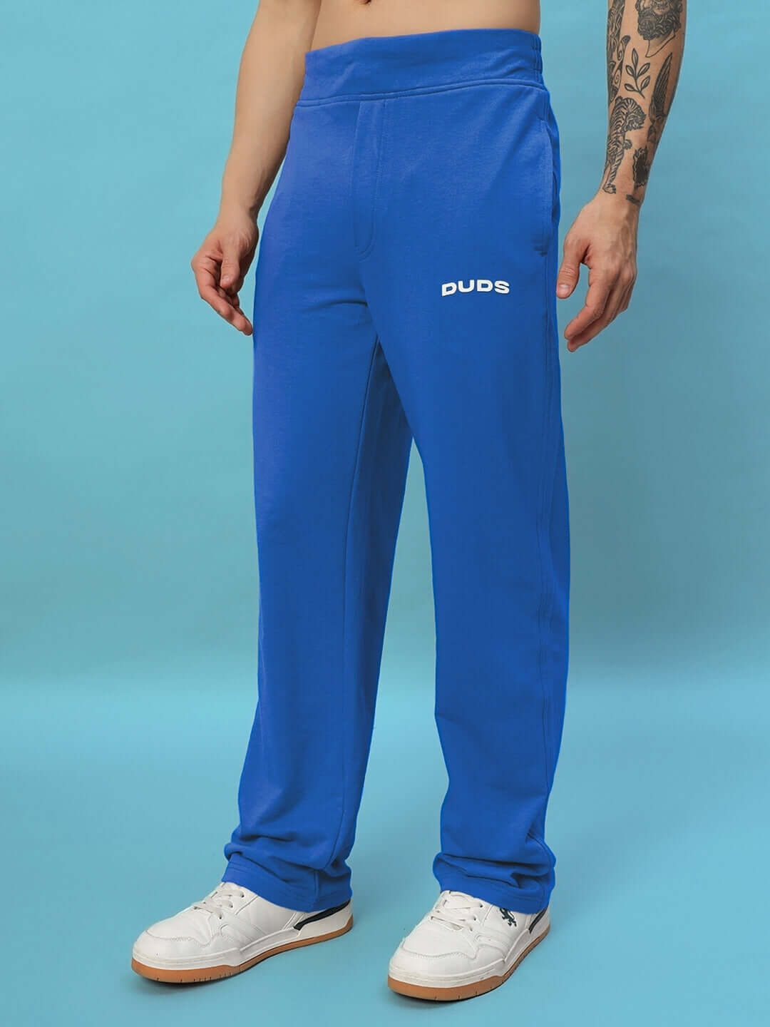 Model wearing NEW ERA RELAXED FIT JOGGERS ROYAL BLUE, showcasing stylish streetwear.