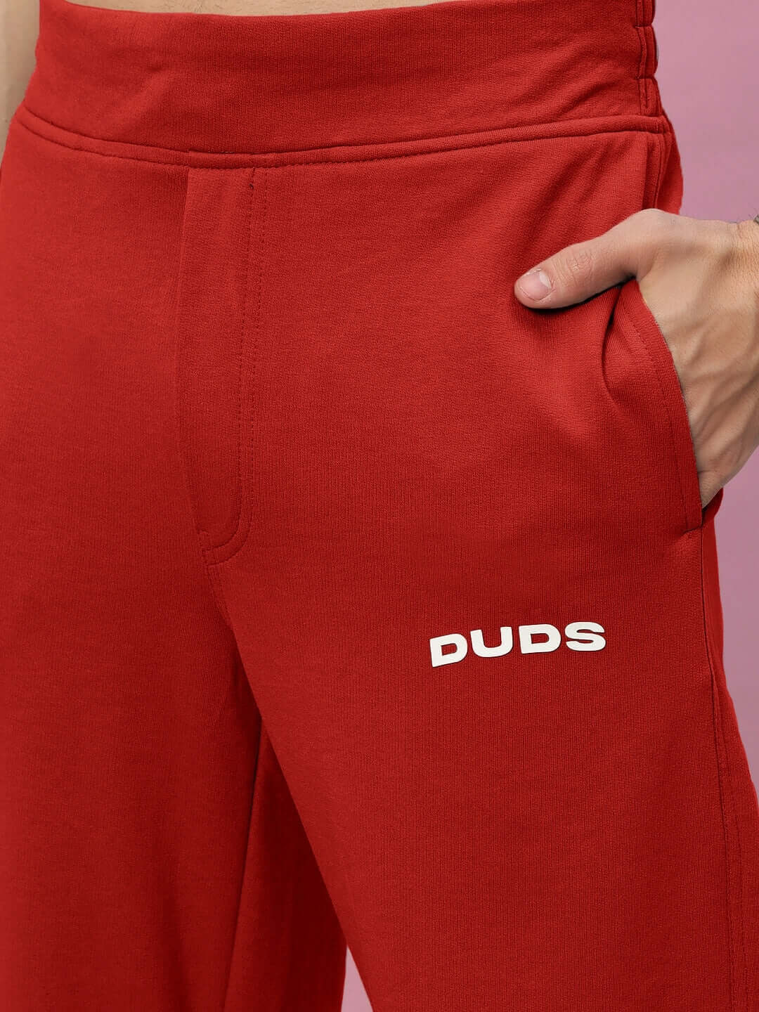 Red relaxed fit joggers by DUDS, featuring a comfortable design and hand-crafted quality. Suitable for custom fit orders.