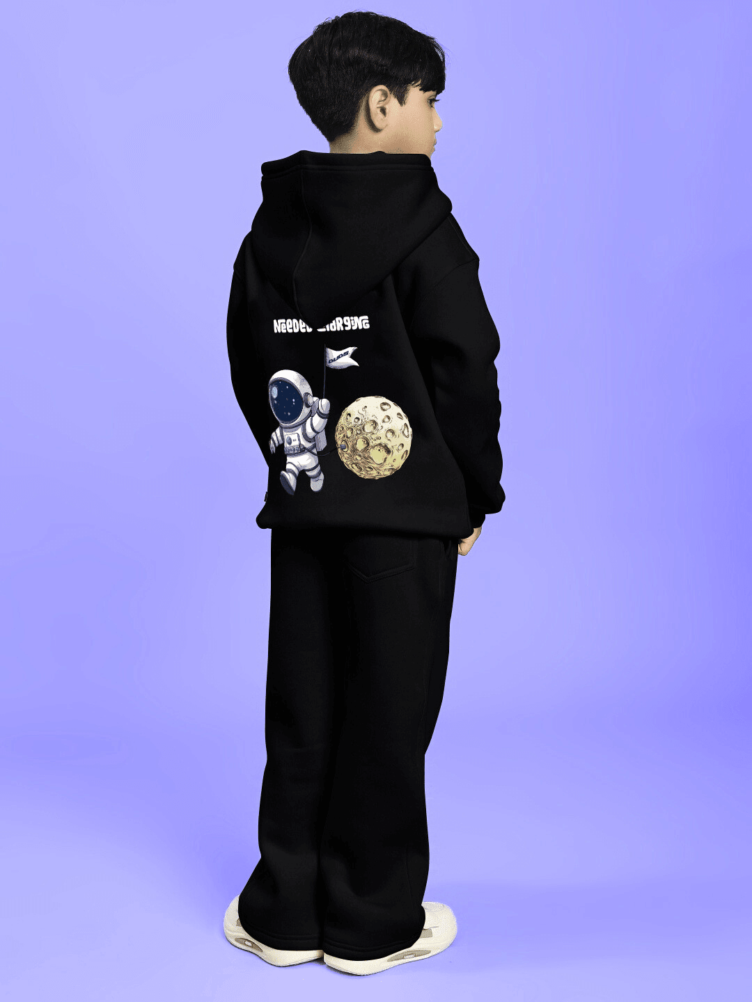 NEXT TO A MOON FLEECE CO-ORD FOR BOYS AND GIRLS BLACK featuring a cozy hoodie and joggers set with an astronaut and moon graphic.