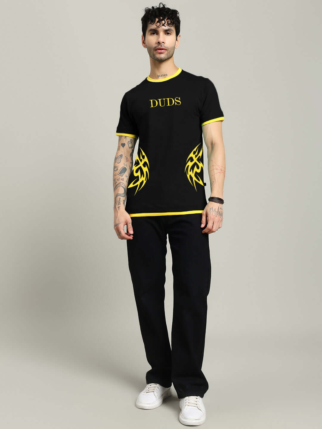 Model wearing NIMO REGULAR FIT T-SHIRT BLACK with yellow graphic design, showcasing streetwear style for comfort and versatility.