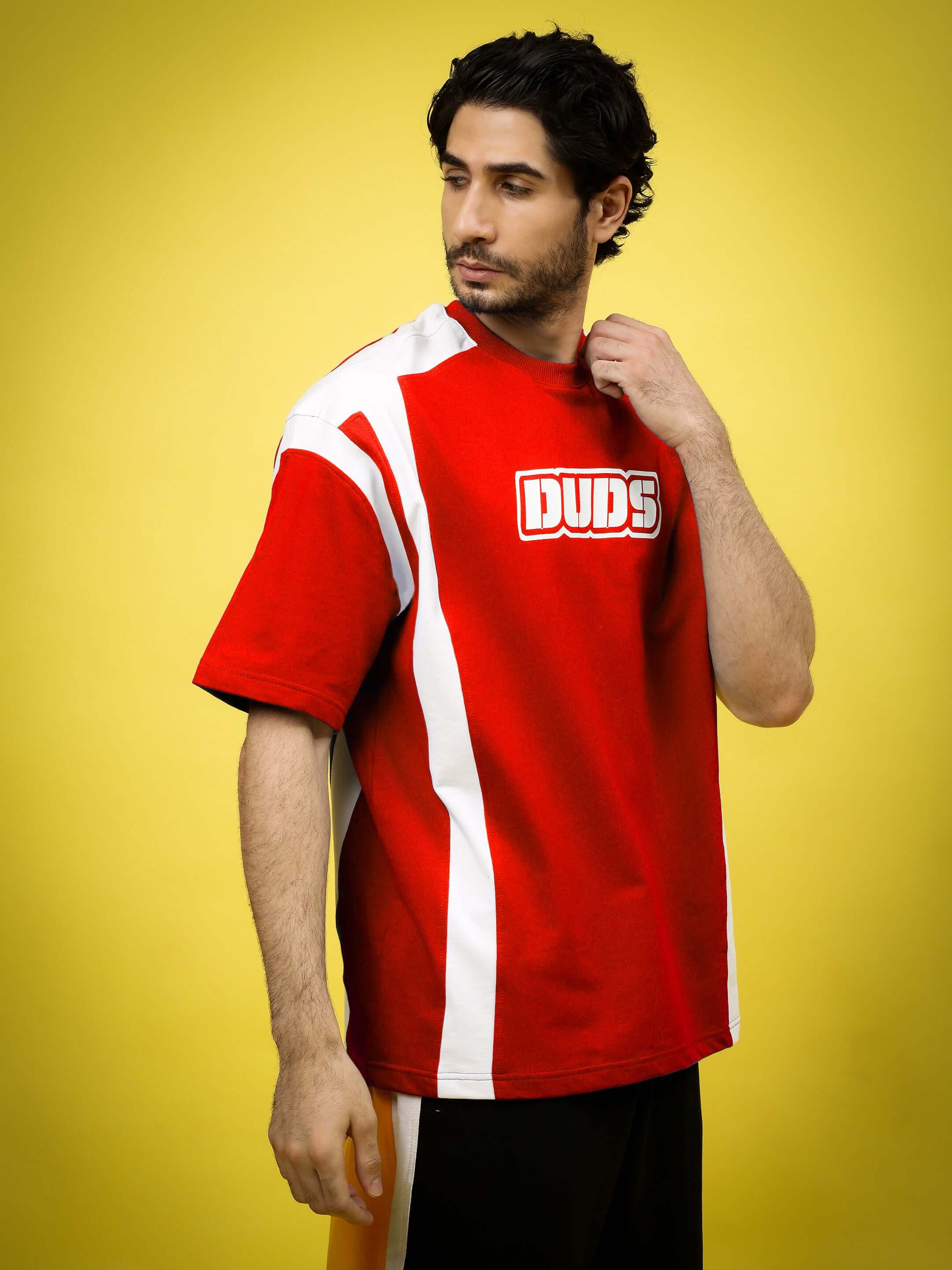 Man wearing NINJA STORM OVER-SIZED T-SHIRT RED with graphic design on yellow background.