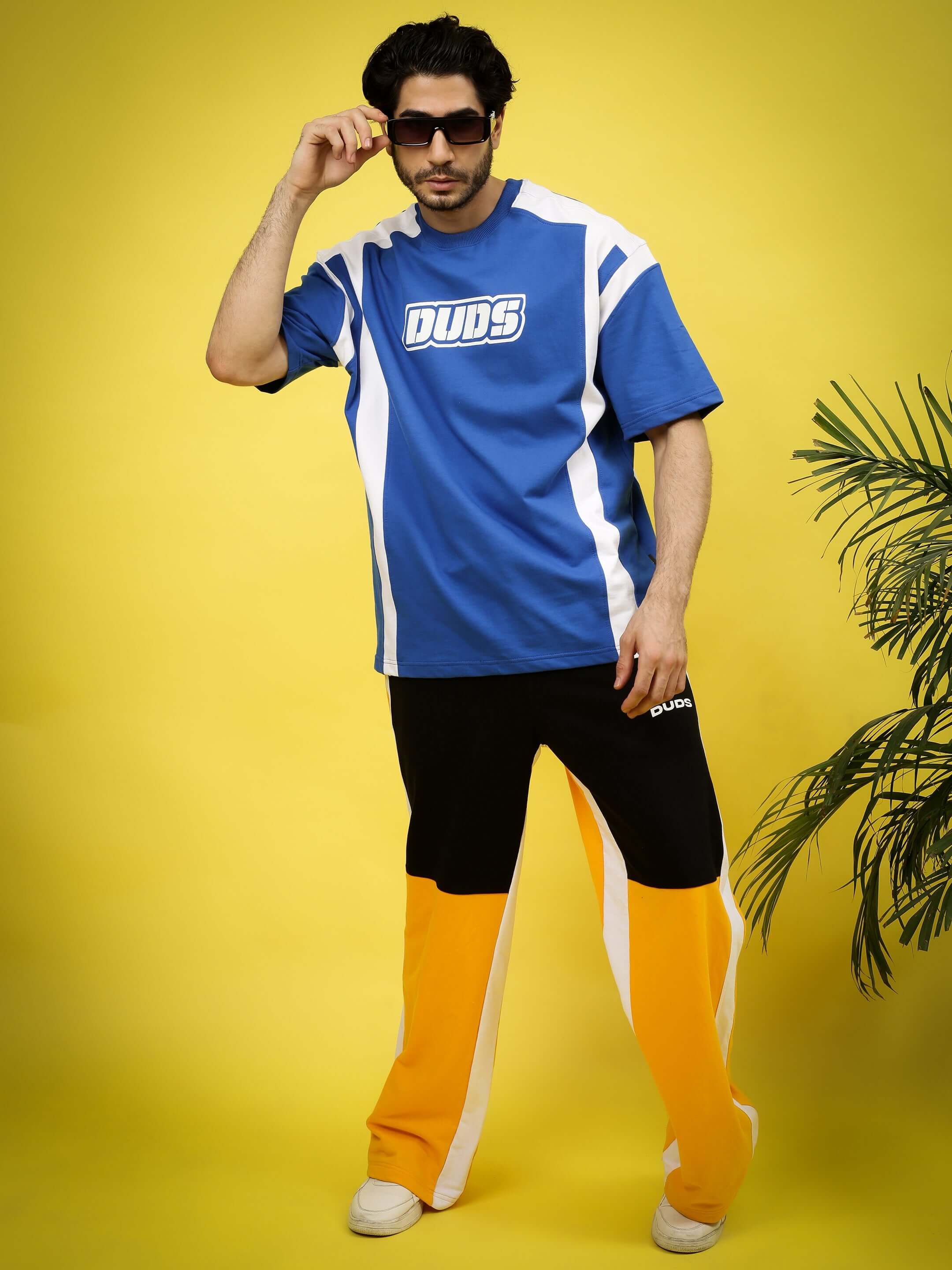 Model wearing NINJA STORM OVER-SIZED T-SHIRT ROYAL BLUE, streetwear fashion in vibrant royal blue and drop-shoulder cut, striking pose.