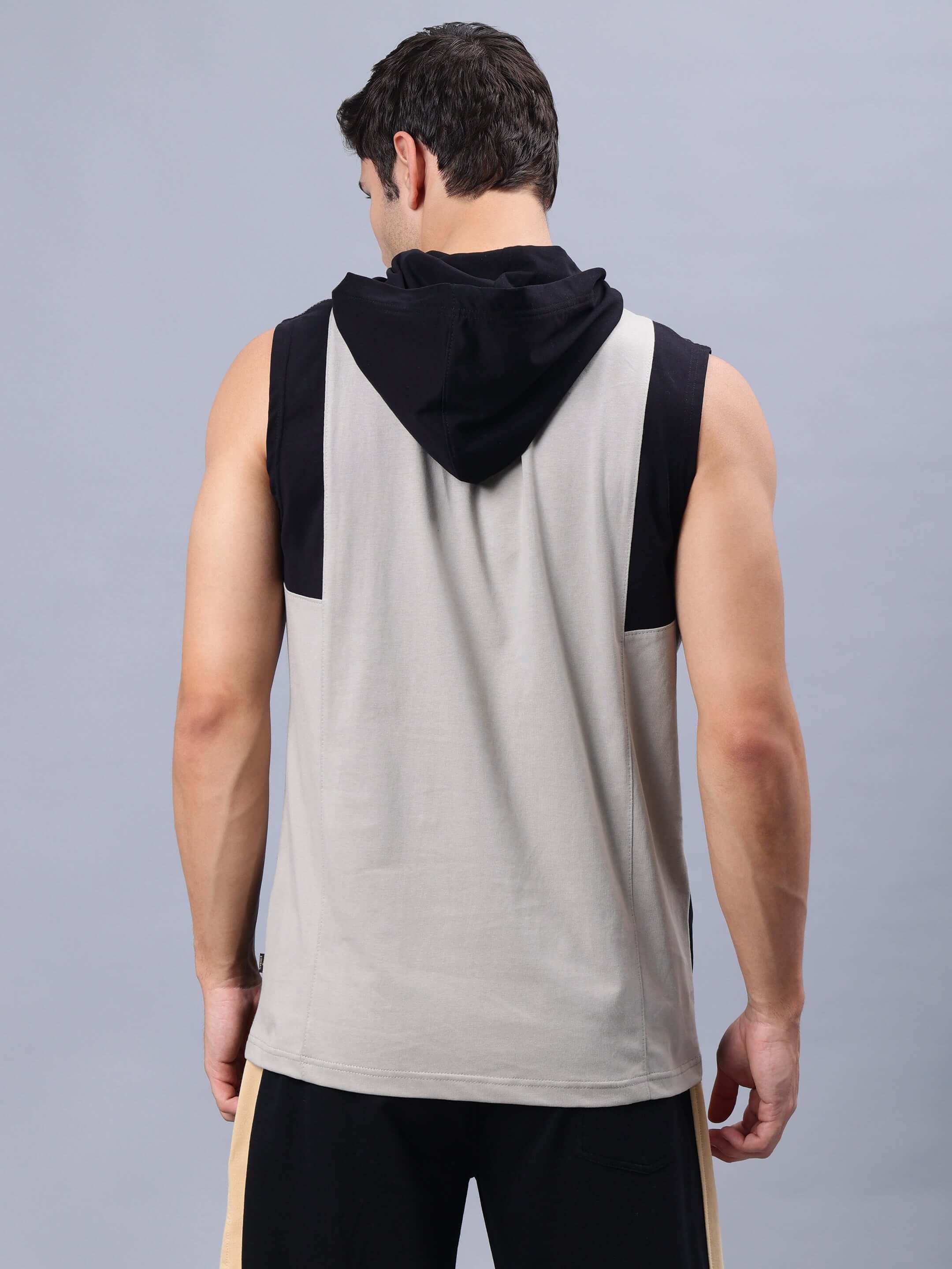 Back view of a man wearing Nirvana Gym regular sleeveless T-shirt in grey and black, featuring a hood and comfortable fit.