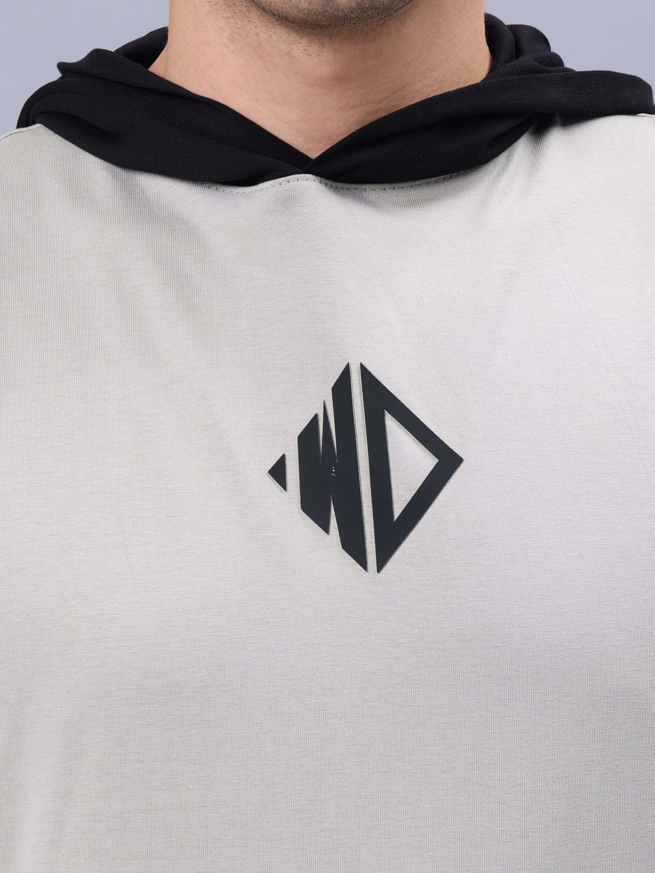 Close-up of Nirvana Gym regular grey-black t-shirt with logo on chest, showing fabric texture and black hoodie lining.