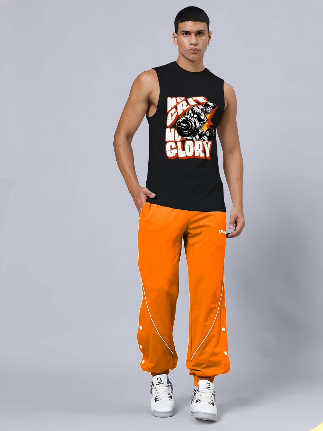 Model wearing NO GRIT NO GLORY GYM RELAXED FIT CO-ORD SET BLACK-ORANGE, emphasizing strength and perseverance in workout gear.