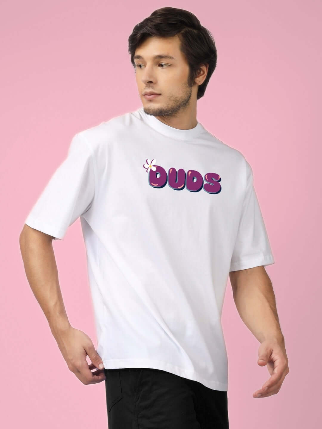 Man wearing NO POS WOW OVER-SIZED PRINTED T-SHIRT WHITE with bold graphics on a pink background.