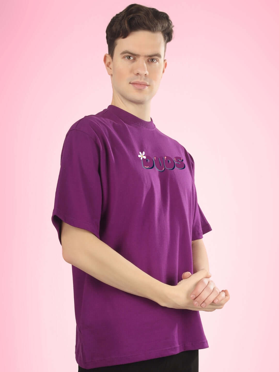 Model wearing NO POS WOW OVER-SIZED PRINTED T-SHIRT PURPLE against a pink background.