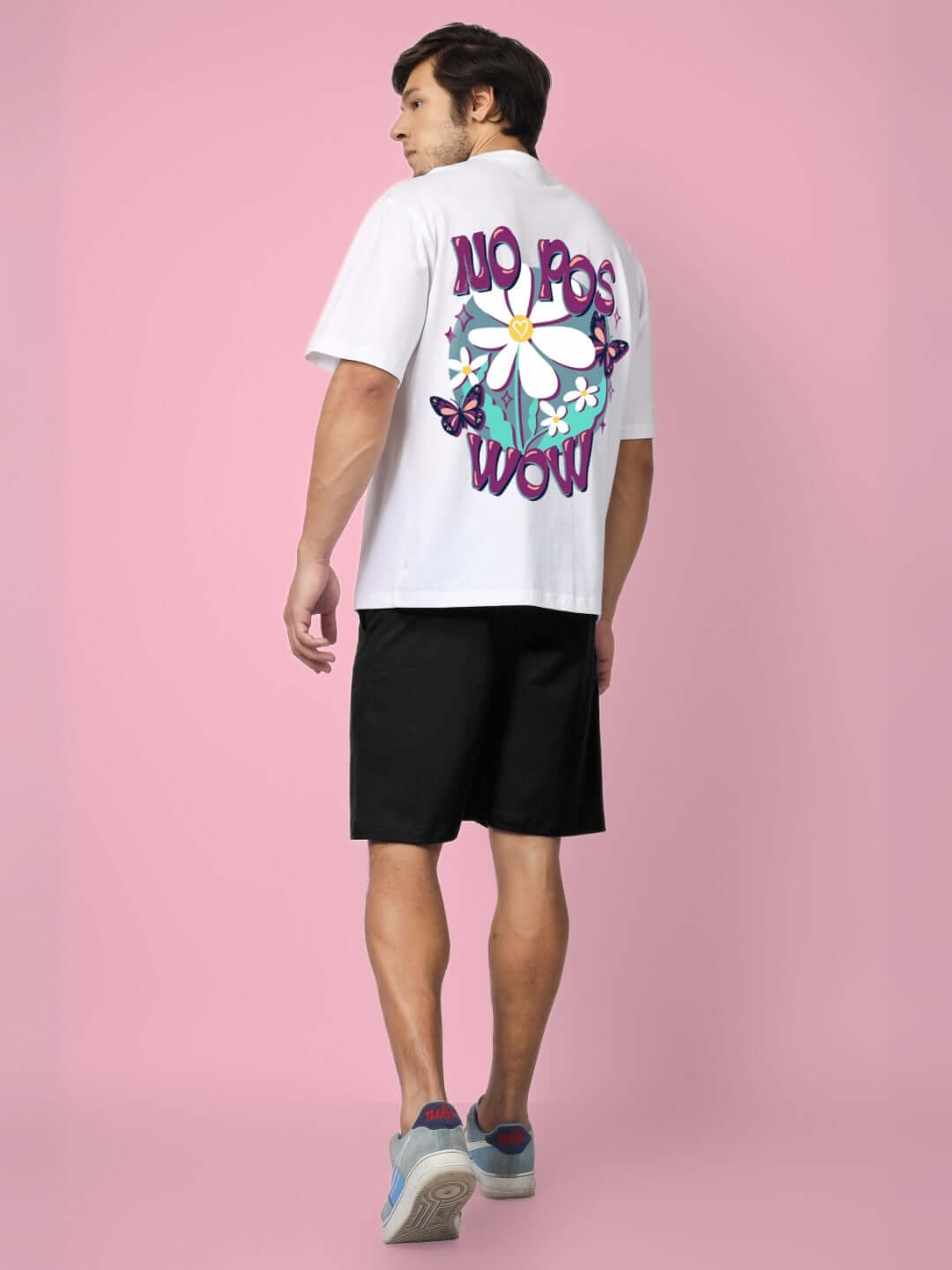 Man wearing NO POS WOW SUMMER CO-ORD SET WHITE BLACK with graphic back design, showcasing casual streetwear style.