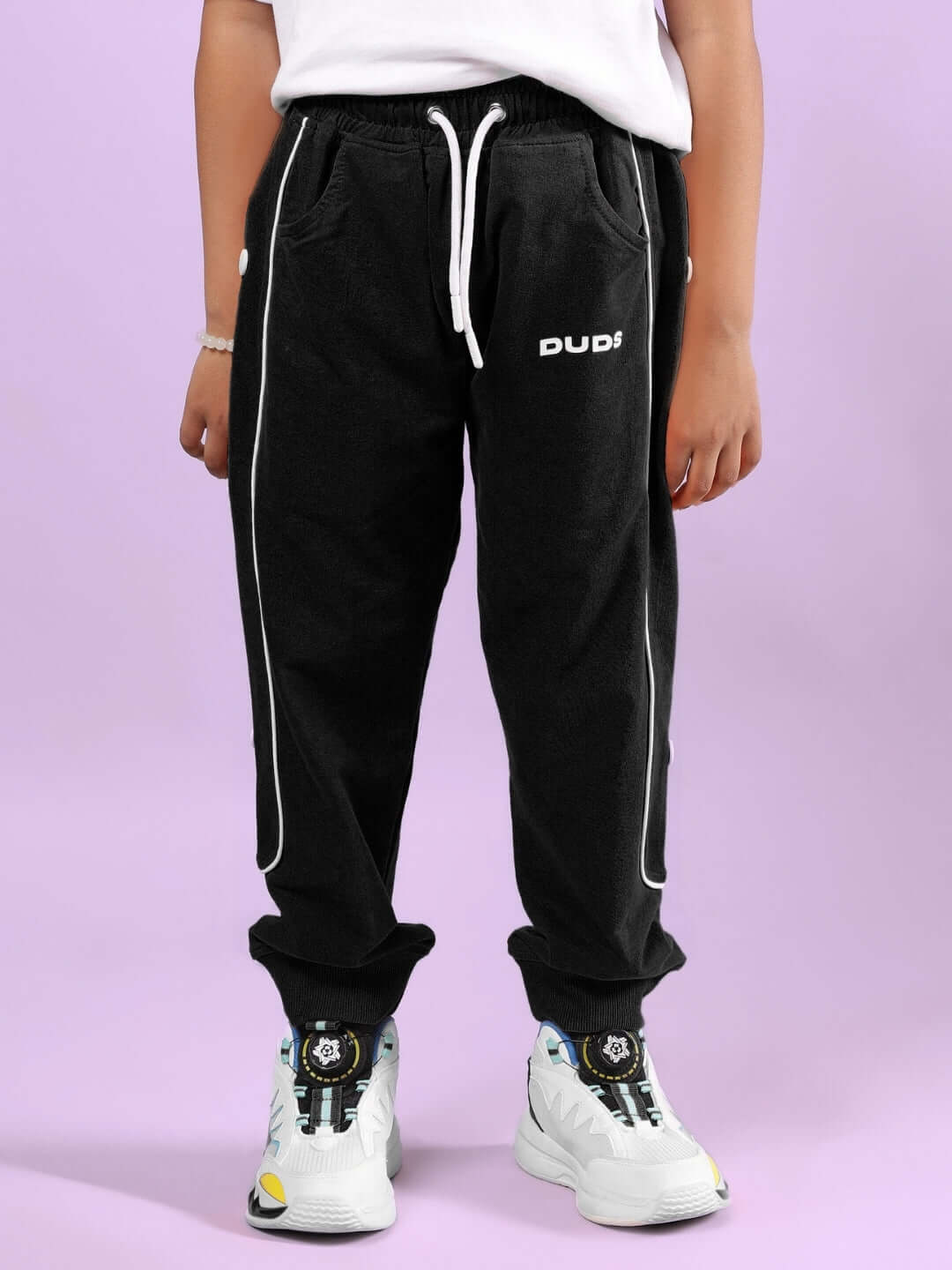 Child wearing NORDIC WOLF CO-ORD FOR BOYS & GIRLS WHITE-BLACK with black joggers and white sneakers.