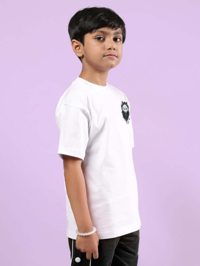 Boy wearing NORDIC WOLF OVERSIZED T-SHIRT FOR BOYS & GIRLS WHITE, standing sideways against a purple background
