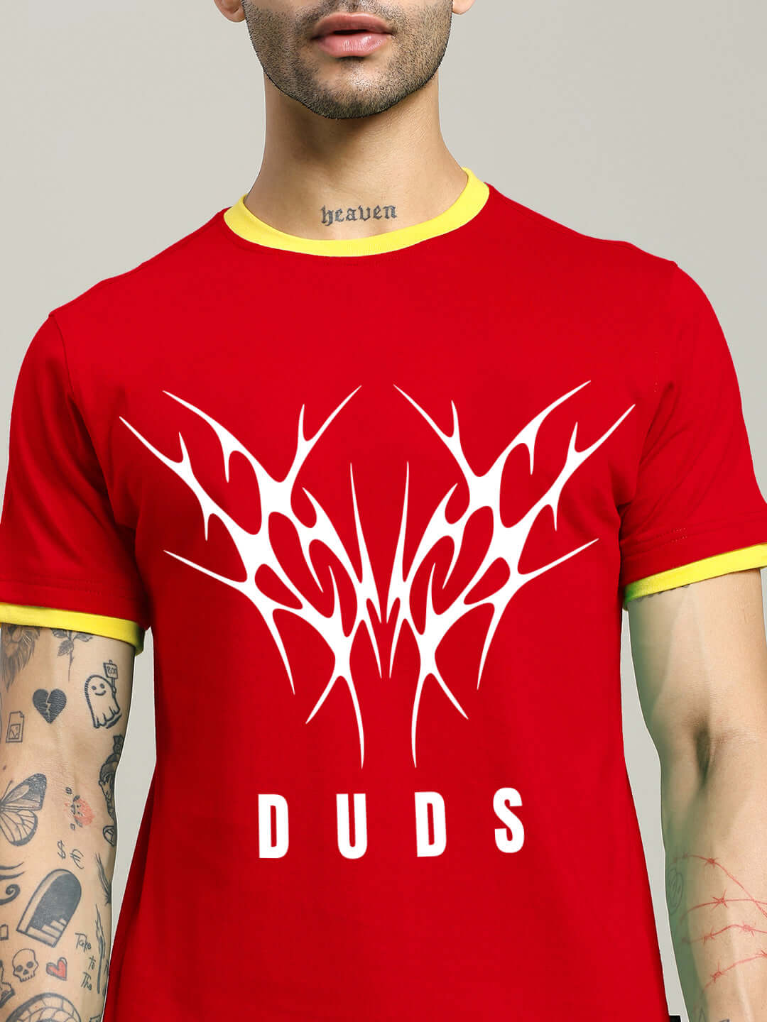 Red Noriba regular fit t-shirt with white graphic design and 'DUDS' text on front, modeled by a tattooed individual.