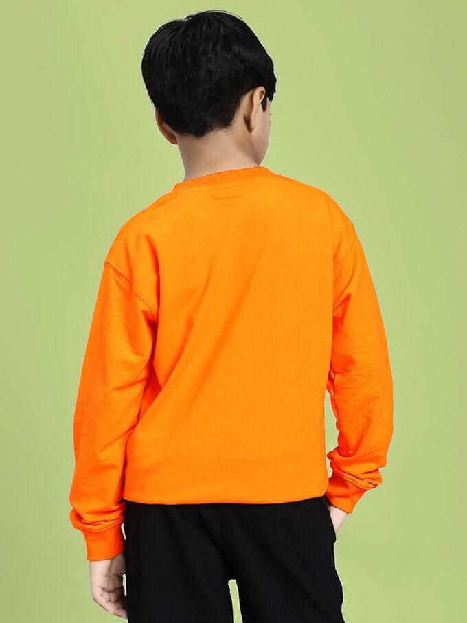 Back view of NOT FAST BUT FURIOUS PRINT SWEATSHIRT BOYS AND GIRLS ORANGE, worn by a child against a green background.