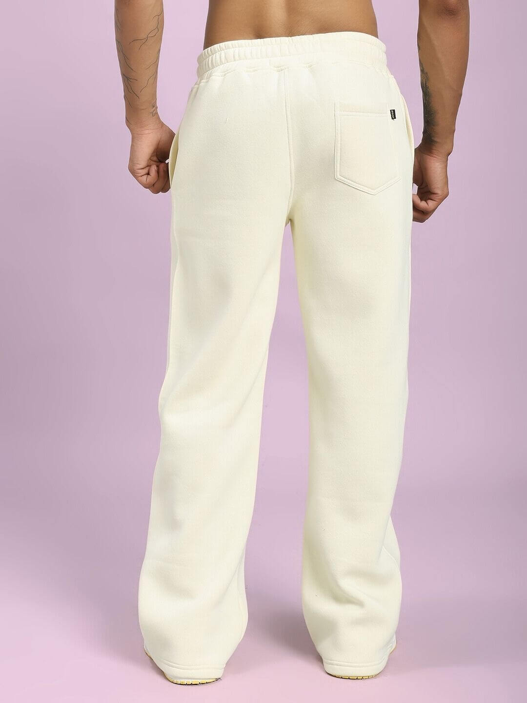 Back view of person wearing OCEAN BUDDIES JOGGER OFF-WHITE showcasing comfortable fit and stylish design.