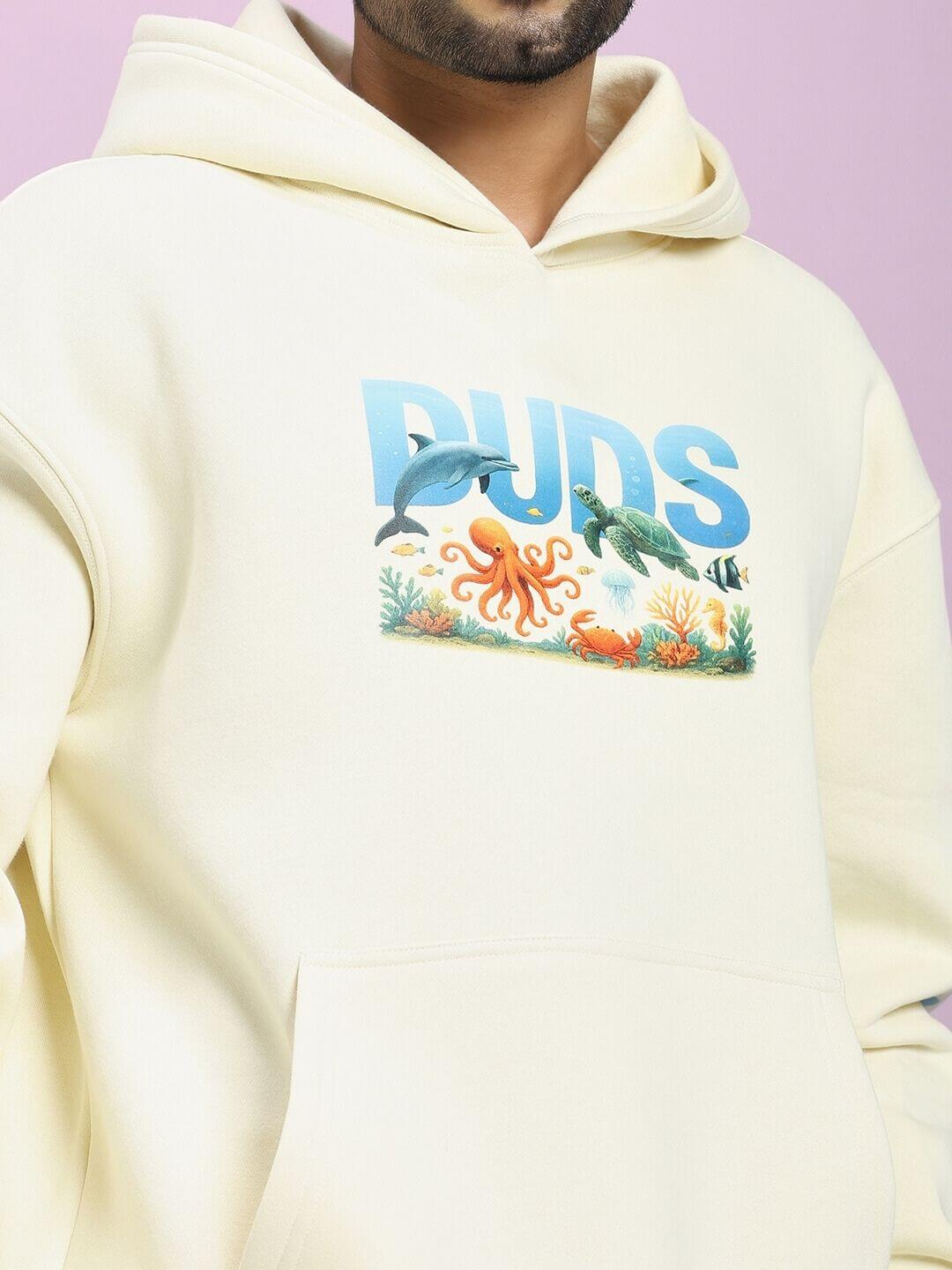 OCEAN BUDDIES FLEECE CO-ORD SET OFF-WHITE hoodie with sea-inspired graphics in vibrant colors, perfect for casual outings.