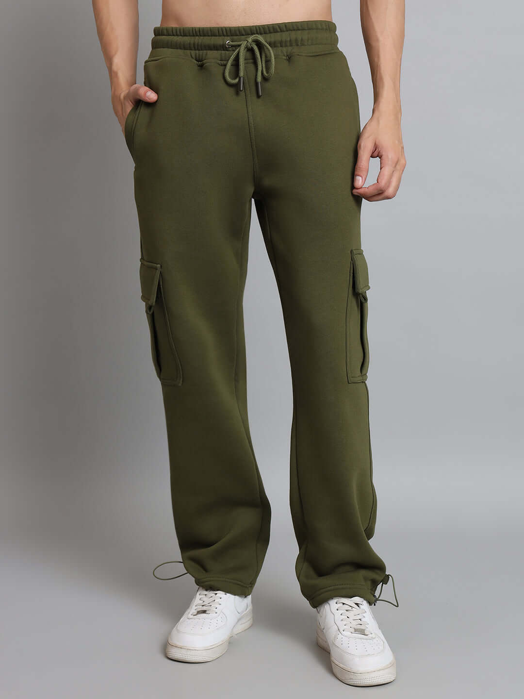Olive green relaxed fit fleece cargo pants with pockets, perfect for casual wear and comfort, shown worn by a person standing.
