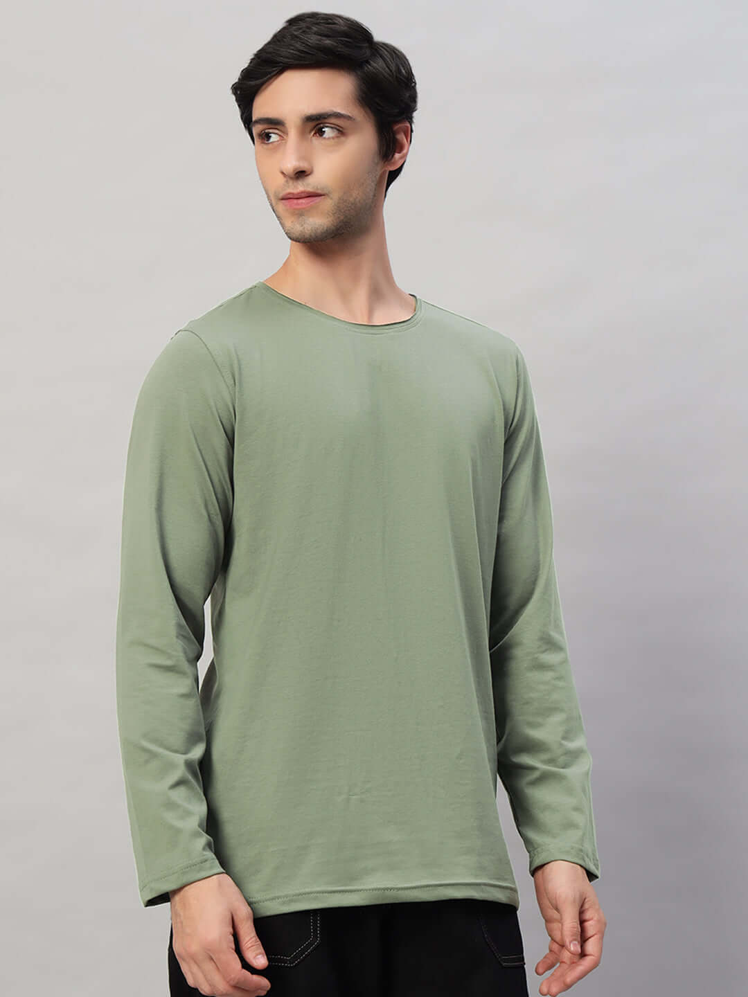 Model wearing OMNI SLIM FIT SWEATSHIRT SAGE GREEN, showcasing sleek design and premium quality fabric for casual or smart layering.