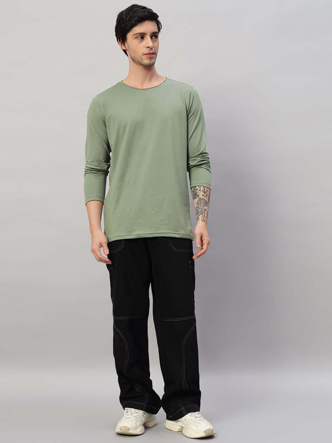 Model wearing OMNI slim fit sage green sweatshirt, 100% cotton, bio-washed. Stylish men’s casual wear, ideal for cool weather.