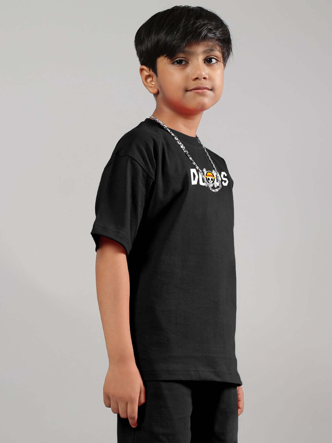 Boy wearing a black One Piece t-shirt by DUDS with a custom fit option.