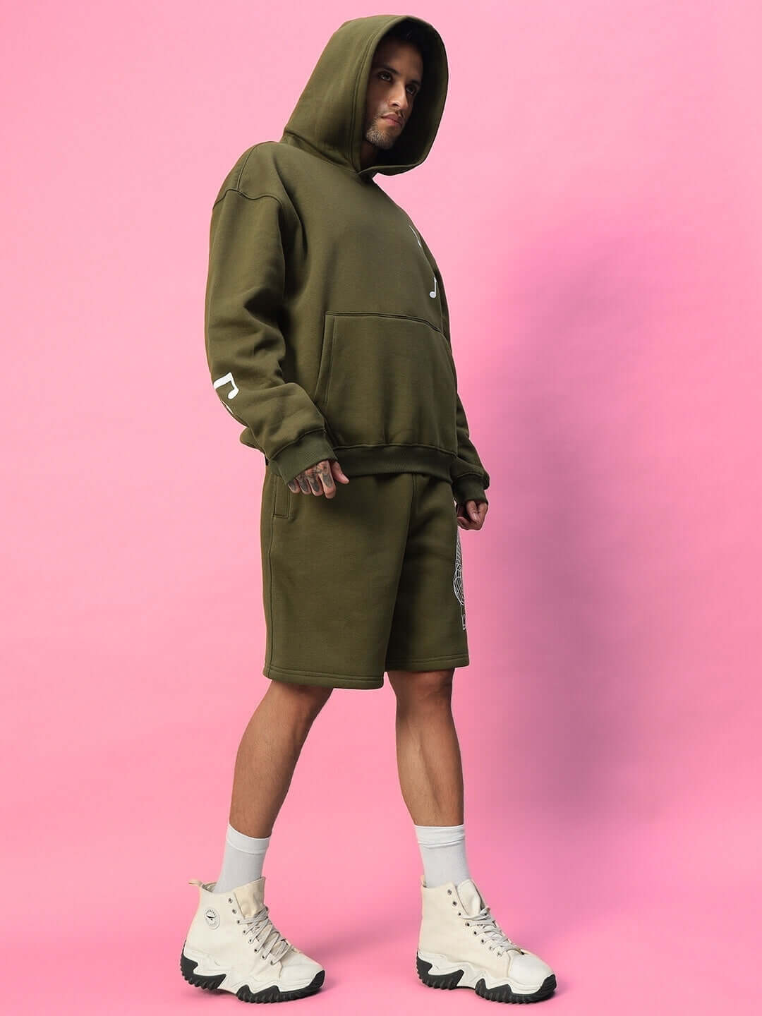 Model wearing OPERA FLEECE CO-ORD OLIVE GREEN against pink background