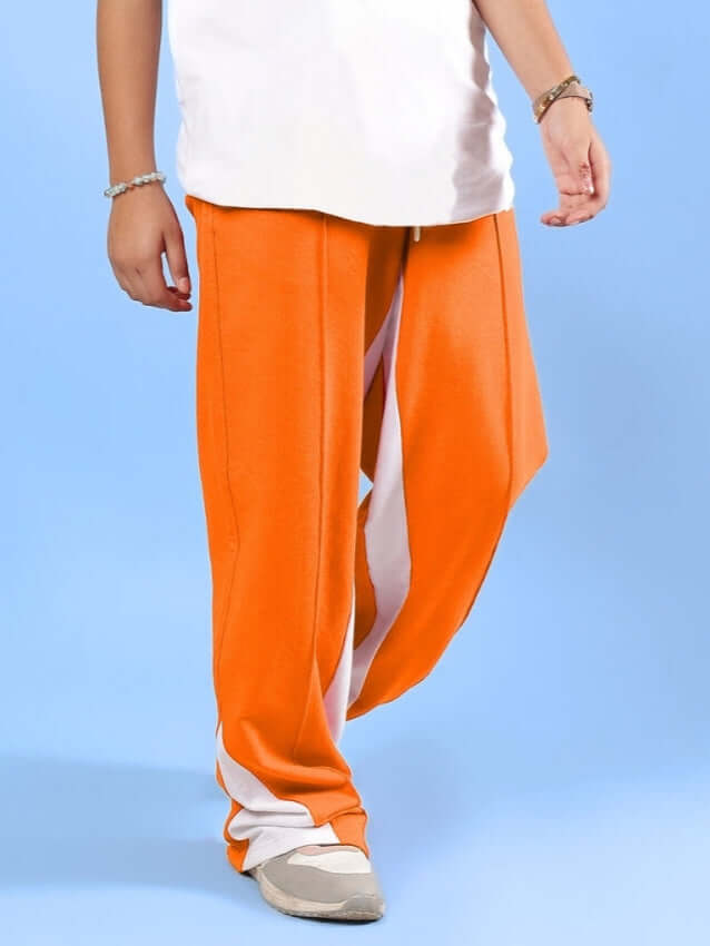 FLOPPY JOGGER FOR BOYS & GIRLS ORANGE - stylish unisex pants displayed on a model.