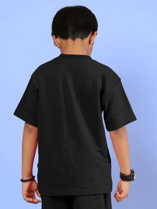 Boy wearing OUTLOOK T-SHIRT FOR BOYS GIRLS BLACK, showcases back view, perfect for comfort and style, suitable for casual wear.