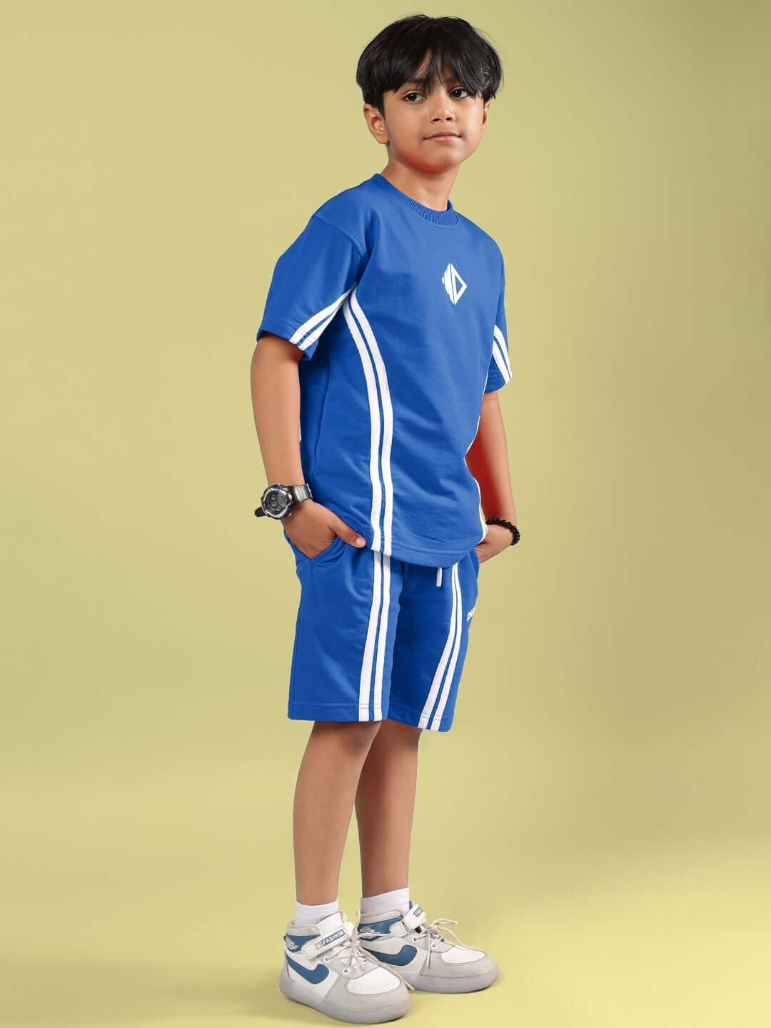 Boy wearing OUTLOOK HALF CO-ORD FOR BOYS GIRLS BLUE with blue t-shirt and matching shorts, featuring a vibrant and energetic style.