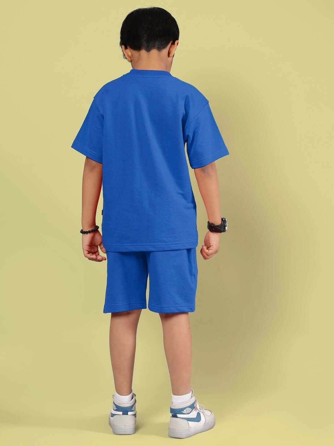 Boy wearing OUTLOOK HALF CO-ORD FOR BOYS GIRLS BLUE outfit, featuring a blue t-shirt and shorts, showcasing back view.