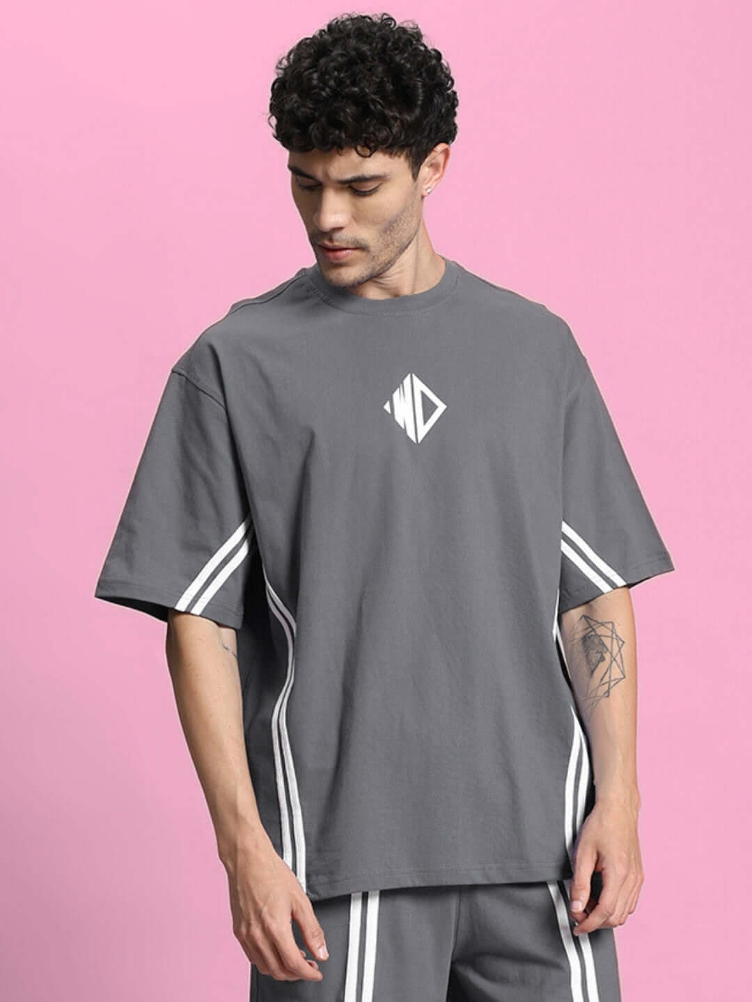 Model wearing OUTLOOK OVER-SIZED T-SHIRT GREY, modern streetwear style, soft relaxed fit, minimal grey tone for versatile pairing.