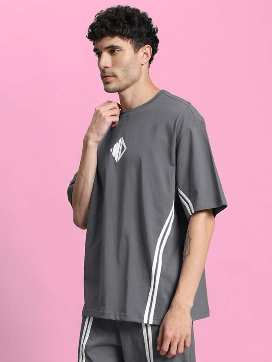 Model wearing OUTLOOK OVER-SIZED T-SHIRT GREY, showcasing modern streetwear style with a relaxed fit and versatile grey tone.