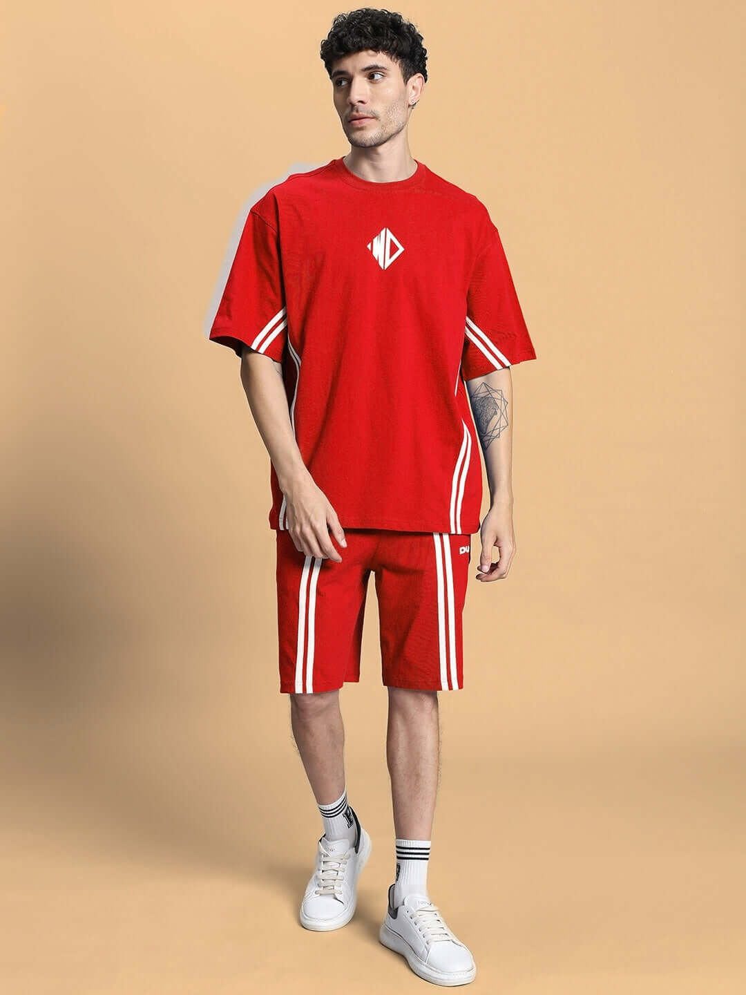 Person wearing OUTLOOK REGULAR FIT SHORTS RED with matching t-shirt, showcasing comfortable and stylish athletic wear.