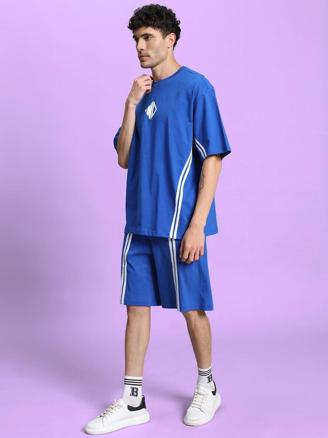 Model wearing Outlook Summer Co-ord Shorts Set in royal blue with premium cotton French Terry fabric against a purple backdrop.