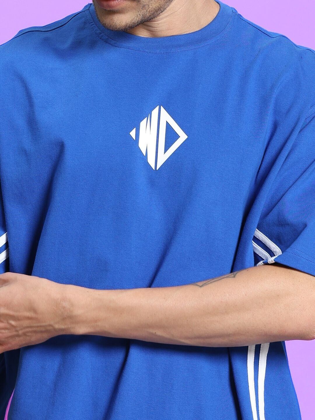 Blue men's co-ord shorts set with geometric logo, made from premium cotton French terry and elastane, displayed on purple background.