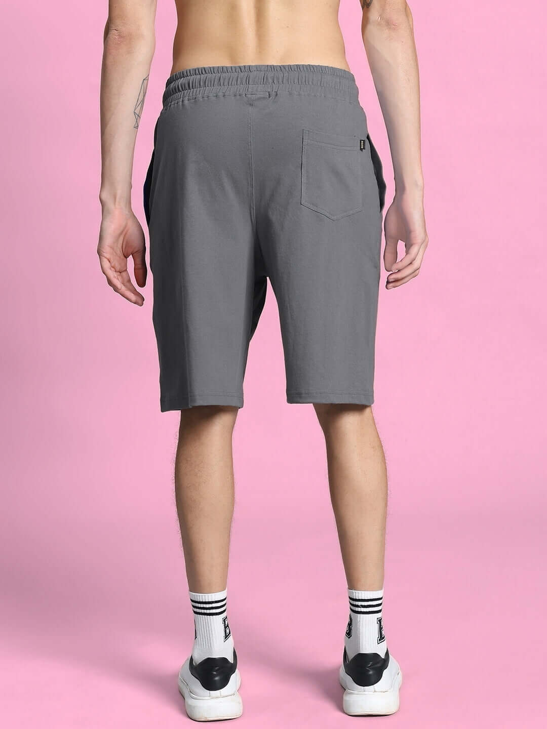 Back view of a model wearing the OUTLOOK SUMMER CO-ORD SHORTS SET GREY, highlighting the comfortable fit and sleek design.